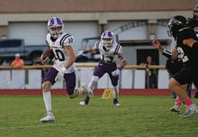 Tyler Mitchell looks for running room during first quarter action of Jacksboro’s win Friday, Oct. 13 over Comanche on the road. The Tigers remained unbeaten with a 30-22 win over the Indians. Photo/Brian Smith