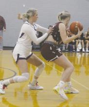 Jacksboro’s Hayden Walker, left, plays defense on the Bowie player during the District 7-3A contest Tuesday, Jan. 2. The Tigerettes remained perfect in the league with a 37-35 win. Photo/Brian Smith