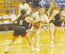 Bryson junior Kaylie Sherrin looks to drive between Olney defenders during the Tuesday, Nov. 21 game. The Cowgirls got out to a quick lead but couldn’t hang on in a tough loss. Photo/Brian Smith