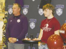 Jacksboro athletic director and head football coach Casey Hubble speaks during a national letter of intent ceremony for Luke Sams, right. Sams signed an NLI to play football Thursday, Jan. 30 for Trinity University in San Antonio. Photo/Brian Smith