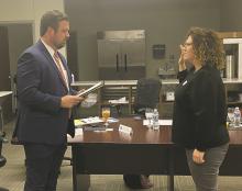 Jacey Brittain, right, is sworn in as the newest Faith Community Hospital board member by board attorney Mason Spiller, during the regular Monday, Oct. 30 meeting. Brittain’s mother, Shelley Owen, served on the board for more than 20 years. Photo/Brian Smith