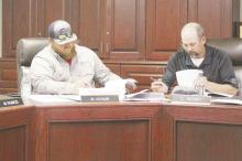 Perrin-Whitt CISD board president Chris Keeney and board member Michael Adams look over the board calendar for the 2025-2026 school year as part of the Monday, April 14 meeting. Photo/Brian Smith