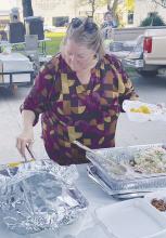 Lions Club member Brenda Tarpley prepares plates of fish and all the trimmings during the annual fish fry Thursday, June 6. Approximately 250 plates were served. Photo/Brian Smith