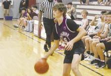 Jacksboro sophomore Isaac Wesson looks to pass inside during a Poolville summer basketball game. The Tigers avenged an earlier loss to Millsap with a 54-46 win in the season finale Tuesday, June 27. Photo/Brian Smith
