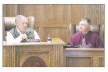 County Judge Keith Umphress, left, speaks at a Tuesday, Feb. 25 commissioners court meeting while commissioner Henry Birdwell, Jr. listens in. The court discussed many items, including using disaster declarations to fund projects. Photo/Brian Smith