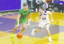 Jacksboro sophomore Eli Jonas (22) plays defense on an Iowa Park player in a recent game. The Tigers used a quick start to pick up their first District 7-3A win Tuesday, Jan. 16 over Henrietta. Photo/Brian