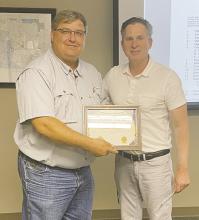 After serving on the Bryson ISD board for 15 years, Frank Hefner was honored for his hard work and dedication by Superintendent Greg London during the Monday, May 26 meeting. Photo/Brian Smith