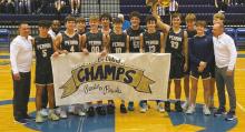 The Perrin Pirates boys basketball team poses with its bi-district sign following its win over Saint Jo last Tuesday, Feb. 21. Courtesy photo