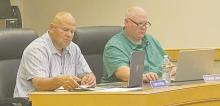 Jacksboro ISD board members Chris Payson, left, and Travis Jonas, look over financial reports during the Monday, June 10 meeting. Photo/Brian Smith
