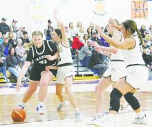 Graford’s Harley Blakeley (41) drives the baseline with Perrin’s Leddy Hill playing defense during first half action Tuesday, Jan. 3. Graford remained perfect in District 21-A with a 39-18 win. Photo/Brian Smith