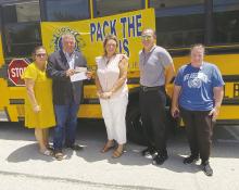Jacksboro Lions Club members club members Kim Veselka, Keith Umphress, Lance McWhorter and Melanie Belcher accept a check from Leann Johnson. The club spent Thursday, Aug. 1 outside the Jack County Courthouse collecting school supplies and cash donations for supplies in their annual Pack the Bus event. In four hours, $1,920 was collected along with a number of bags of school supplies. All supplies and cash will be given to the three Jacksboro ISD campuses for students in need.