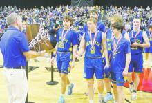 Bryson Athletic Director Kevin Ray, left, presents the runner-up trophy to Bryson players following the squad’s loss in the Class A Division 2 State Championship game. Photo/Brian Smith