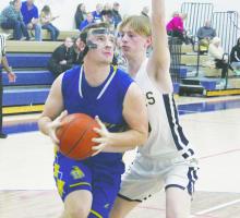 Bryson’s Tyler Cotter, left, drives inside against Perrin in Friday’s 83-26 Perrin win. Photo/Brian Smith