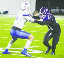 Jacksboro’s Josh Salazar works to get around Gunter’s Colson Wood during their Friday, Dec. 1 game at Denton’s C.H. Collins Stadium. Jacksboro had its season ended in the Regional Final in a 55-33 loss. Photo/Brian Smith