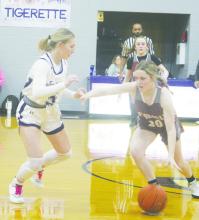 Jacksboro’s Kylie Tullous (5) plays defense on Poolville’s Caitlin Pope during first half action of the Tigerettes’ 80-6 win Tuesday, Dec. 5 over the Lady Monarchs. Photo/Brian Smith