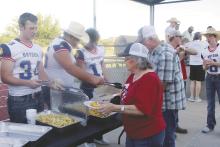 Bryson hosted its annual Meet the Cowboy event Friday night at Tiger Stadium. Fans had a chance to meet the athletes playing Fall sports such as football and volleyball. In conjunction with the event, a fish fry for the community was held sponsored by the Bryson Athletic Booster Club. Here, senior football player Tyler Cotter serves french fries to hungry patrons. Later, the football team put on its pads for the first time. Photo/Brian Smith