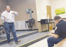 Jack County Precinct 2 Commissioner Kenny Salazar speaks during a meeting, which was held to discuss precinct matters, Tuesday, Feb. 7. About 20 people attended the hour-long meeting, including Constable Clyde Watson, right. Photo/Brian Smith
