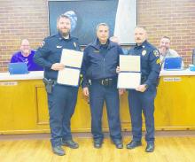 Jacksboro Police Chief Bryan Corb, center, presents Merit Certificates to both School Resource Officer Daniel Moody, left, and Sgt. Adam Rydlinski for their efforts in rescuing a construction worker on top of the Jacksboro High School gym last month. Photo/Brian Smith