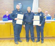 Jacksboro Police Chief Bryan Corb, center, presents Merit Certificates to both School Resource Officer Daniel Moody, left, and Sgt. Adam Rydlinski for their efforts in rescuing a construction worker on top of the Jacksboro High School gym last month. Photo/Brian Smith