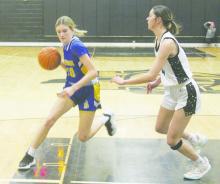 Cowgirl freshman Jossy Whitfill drives into the lane during a non-district game with Archer City. Bryson suffered a 57-10 loss to host Newcastle. File photo