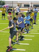 Jacksboro Elementary School hosted its annual Field Day for students Monday, May 22. Students competed in the sprint relay (left) and also the class tug of war competitions to determine a class champion for each grade. There were also fun houses and snow cones for everyone. Photos/Brian Smith