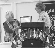 Lanna Moxley, left, the long time piano player at Jacksboro Lions Club meetings, was honored for her recent work with a lifetime membership to the Texas Lions Camp, which gives camping opportunities to disabled youth. Photo/Brian Smith