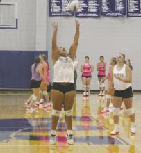 One of the Tigerettes sets a ball for a teammate during the Tuesday, July 23 game against Archer City. Photo/Brian Smith