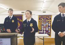 Keelyn Merworth of the Jacksboro Future Farmers of America Chapter makes a point during an Ag Issues presentation made to the Jacksboro Lions Club during their Oct. 26 presentation while Eli Jonas, left, and Eric Pizana listen. The presentation was on cloning. Photo/Brian Smith