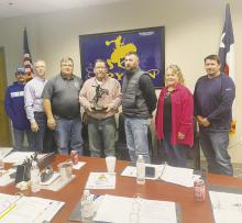 Bryson ISD Board President T-Bob Hauger, center, is awarded with a plaque for his more than 20 years of service during the board’s Monday, Oct. 16 meeting. Hauger announced his resignation during the meeting. Photo/Brian Smith