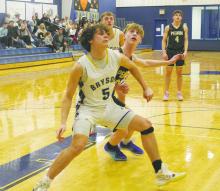 Bryson’s Caleb Allen (5) blocks out Perrin’s Evan Thompson during the Pirates’ win Tuesday, Feb. 13 over the Cowboys. Photo/Brian Smith