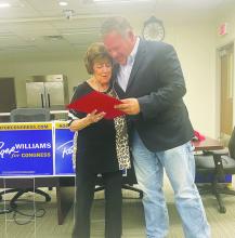 Jack County Judge Keith Umphress presents Carolyn Nichols a proclamation from State Senator Drew Springer’s office honoring her husband Joe Paul for his work in the country music industry. The presentation was made during Congressman Roger Williams’ town hall meet Oct. 11 at the Faith Community Hospital Board Room. Nichols was also a county commissioner. Photo/Brian Smith