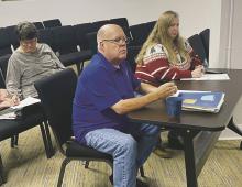 Jack County Treasurer Brad Campsey and Assistant County Auditor Kim Long Morris listen to a question about bills during the Jack County Commissioners Court meeting Wednesday, Dec. 27. Photo/Brian Smith