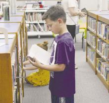As part of the summer reading program at the Gladys Johnson Ritchie Library, students picked out books for their pleasure. Students will have books read to them at 10:30 a.m. each Tuesday in June. Photo/Brian Smith