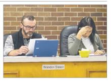 Jacksboro City Council members Brandon Sisson and Libby Gonzales look over the bills Monday, Dec. 9 during the city council meeting. Photo/Brian Smith