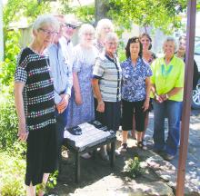 Clothes Closet friends honor Lynn Pruitt with a statue during a recent summer ceremony. Photo/Brian Smith
