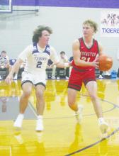 Jacksboro’s Lando Belcher plays defense on Muenster’s Brody Tyler during the Tiger’s season opener Tuesday, Dec. 5. Jacksboro came back from a 19-point deficit to cut the final score to 49-43. The squad will face Tolar at home at 7:30 p.m. Friday, Dec. 15. Photo/Brian Smith