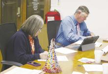 Commissioners Henry Birdwell, Jr. and Amy Salazar look over the bills during the Jack County Commissioners Court meeting Monday, April 28. Photo/Brian Smith
