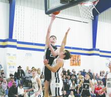 Graford’s Colin Roberts takes a shot with Perrin’s Ryan Richerson trying to defend the shot. Graford use 9-10 shooting in the fourth quarter and a 25-point game from Roberts to post a 67-53 win over the Pirates. Photo/Brian Smith