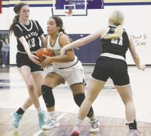 Perrin’s Aaliyah Brown, center, drives between two Graford defenders in a recent game. Brown had 26 points Tuesday, Jan. 10 in a 66-25 win over Garner. Photo/Brian Smith