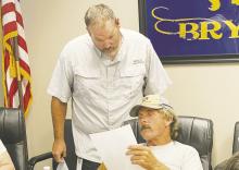 Bryson Principal Gary Kirby answers a question from board member Danny Lewis during the Monday, July 29 board meeting. Photo/Brian Smith