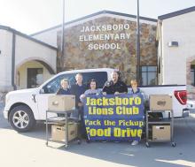 Jacksboro Lions Club members will be outside Lowe’s Market from 3-6 p.m. Nov. 1-3 to take part in its annual Pack the Pickup benefiting the Jack County Food Pantry. Here, Lions Club members receive a donation last year from Jacksboro Elementary School personnel and students. File photo