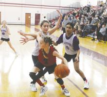 Jewel Salazar, left, and Hilda Romero of Jacksboro play defense on Victory Christian Academy’s Willis during the 5th grade championship game of the Wise County Youth Basketball League. Jacksboro posted a 23-19 win Saturday, Feb. 4. Photo/Brian Smith