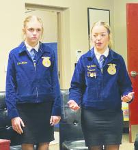 Perrin Ag Issues team members Jaylee Holmes, right, and Shiloh Wilson speak on the cons of a four-day school week during a Perrin-Whitt CISD school board meeting. The team is preparing to compete at contests over the next several weeks. Photo/Brian Smith