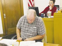 Jack County Precinct 4 Commissioner Terry Ward looks over the annual financial report during the Monday, Dec. 11 meeting. The court heard several departments were over their budget last year. Photo/Brian Smith