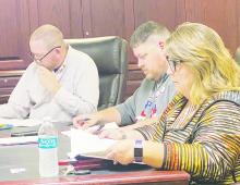 Perrin-Whitt CISD board members, left to right, Mark Saims, Chad Lambert, and Delaina Henderson go over the district’s audit report during the board meeting Thursday, Nov. 30. The district received a clean audit. Photo/Brian Smith