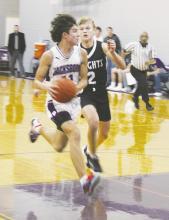 Kasey Ray Swan (11) heads to the basket with a Lindsay defender on his heels. Swan led the team in scoring as Jacksboro beat the Knights Friday night at home. Photo/Brian Smith
