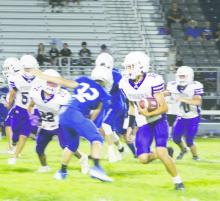 Kase Dennis (running the ball) looks for daylight during the JV White season opener Thursday, Aug. 24 with Peaster. The Tigers came through with a big second half both offensively and defensively in a come from behind 22-8 win. Photo/Brian Smith