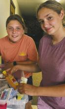 Jack County 4-H members McKinlea Worthington and Jaci Robinson help organize disaster supplies to send to Perryton, the site of a recent tornado. The Jack County Long Term Relief Committee has these supplies on hand from its tornado last year to share with other hard hit communities. Courtesy photo