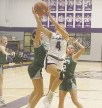 Top: Hayden Walker (4) drives into the lane with two Santo defenders on her. Walker had 14 points in a 39-33 win over the Lady ‘Cats. Bottom: Emory Inman makes a pass Saturday, Nov. 9. Photos/Brian Smith
