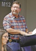 Sheriff T-Bob Hauger lays out the cost to provide a school resource officer to each of the three school districts in Jack County. Also pictured is Bryson ISD school board member Shelby Leatherwood. Photo/Ashley Barner